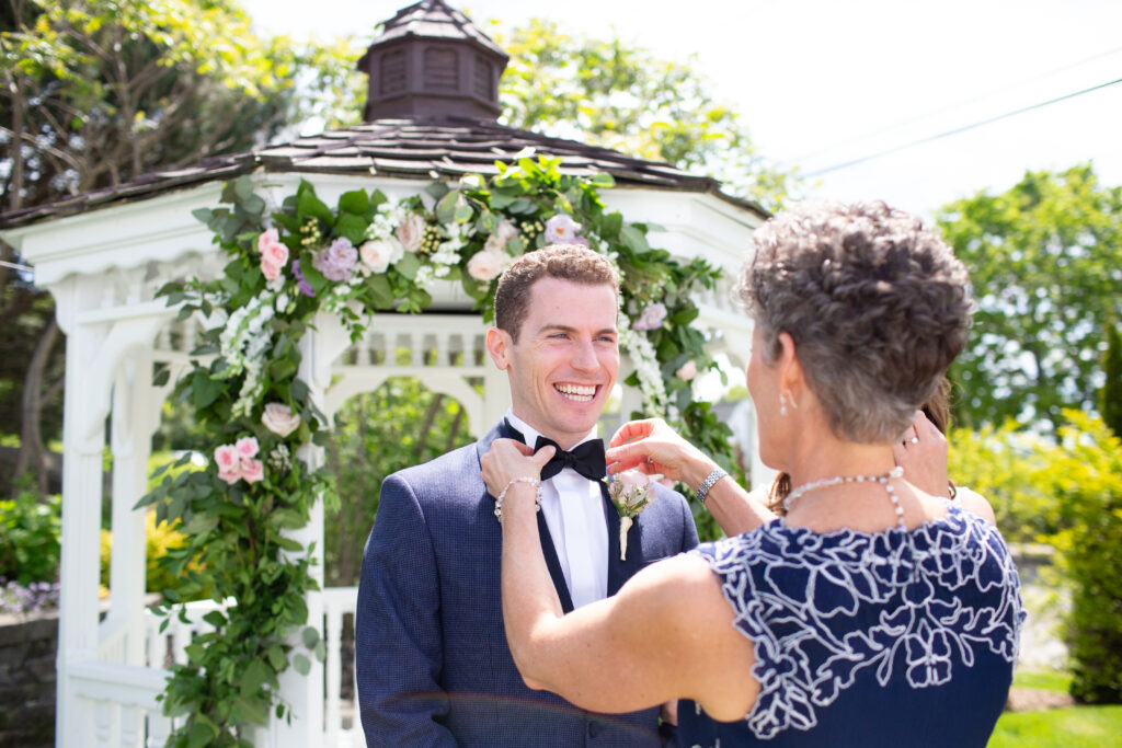 grooms mom fixing his bowtie