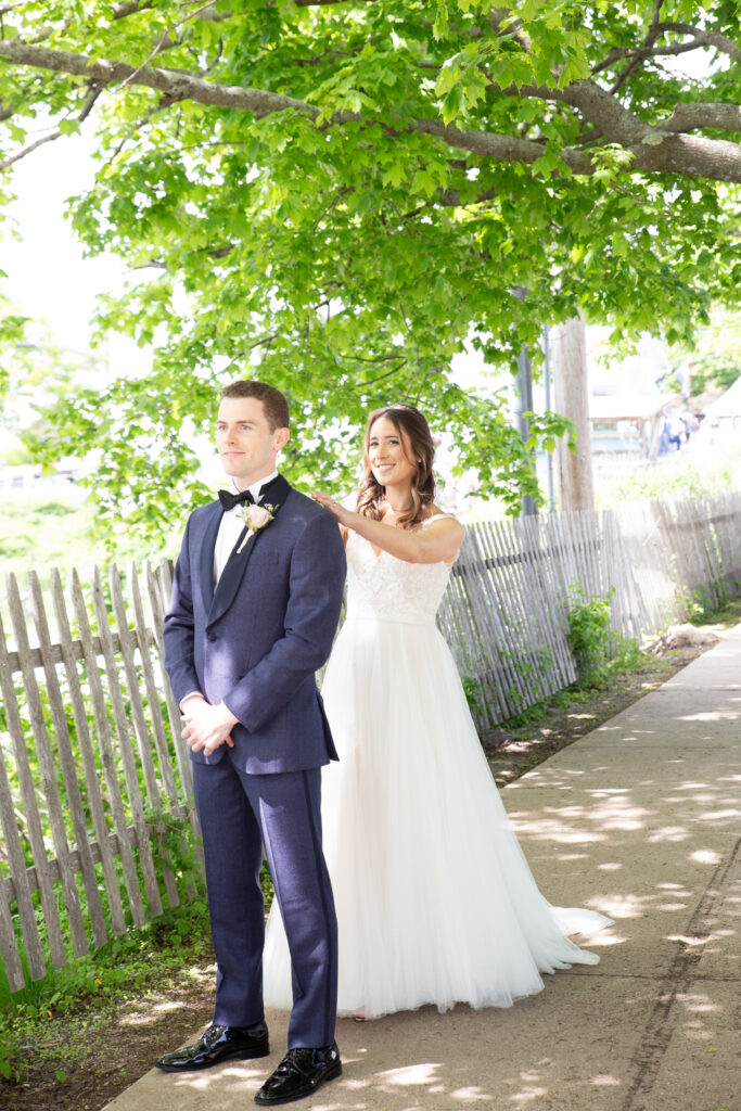 first look bride tapping groom on the shoulder 