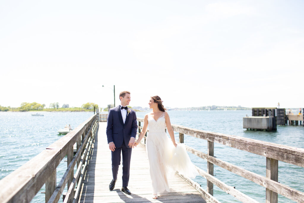 bride and groom walking on the dock