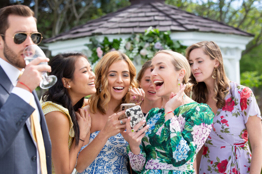 brides friends laughing at a photo