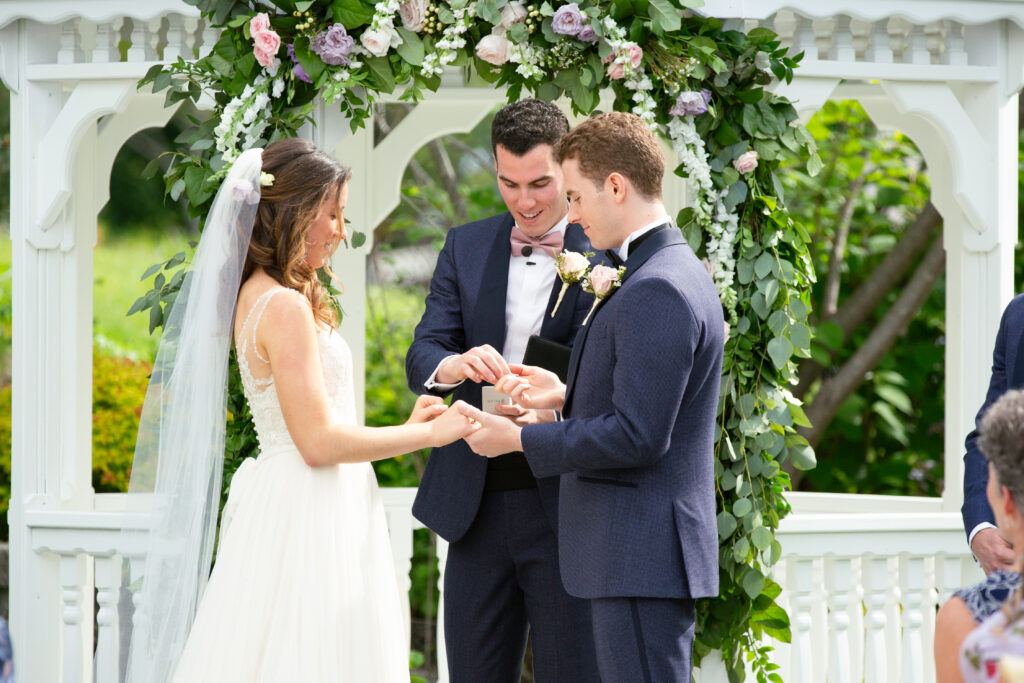 bride and groom at the alter exchanging rings