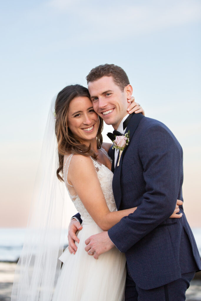 bride and groom smiling and looking at the camera 