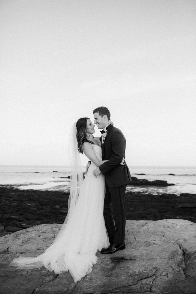 black and white of bride and groom looking at each other 