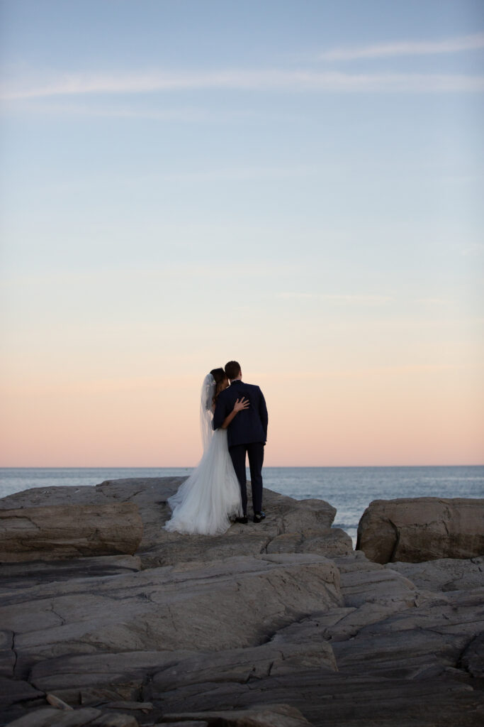 sunset with the bride and groom on the rocks 