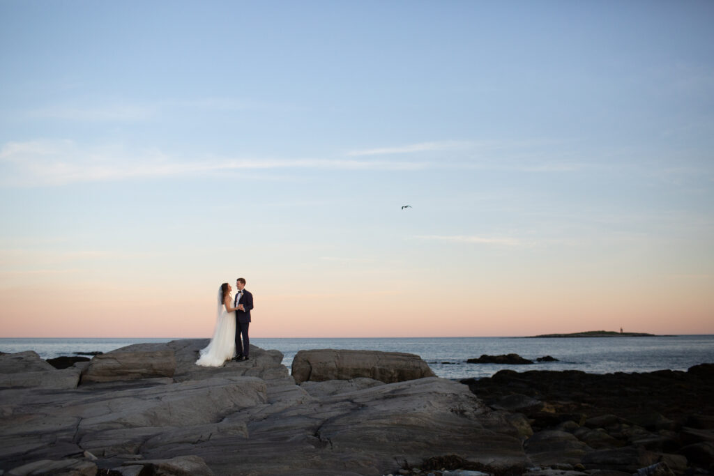 sunset with the bride and groom on the rocks 