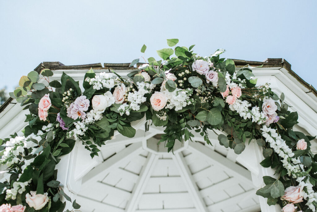 pink flowers on garland on gazebo 