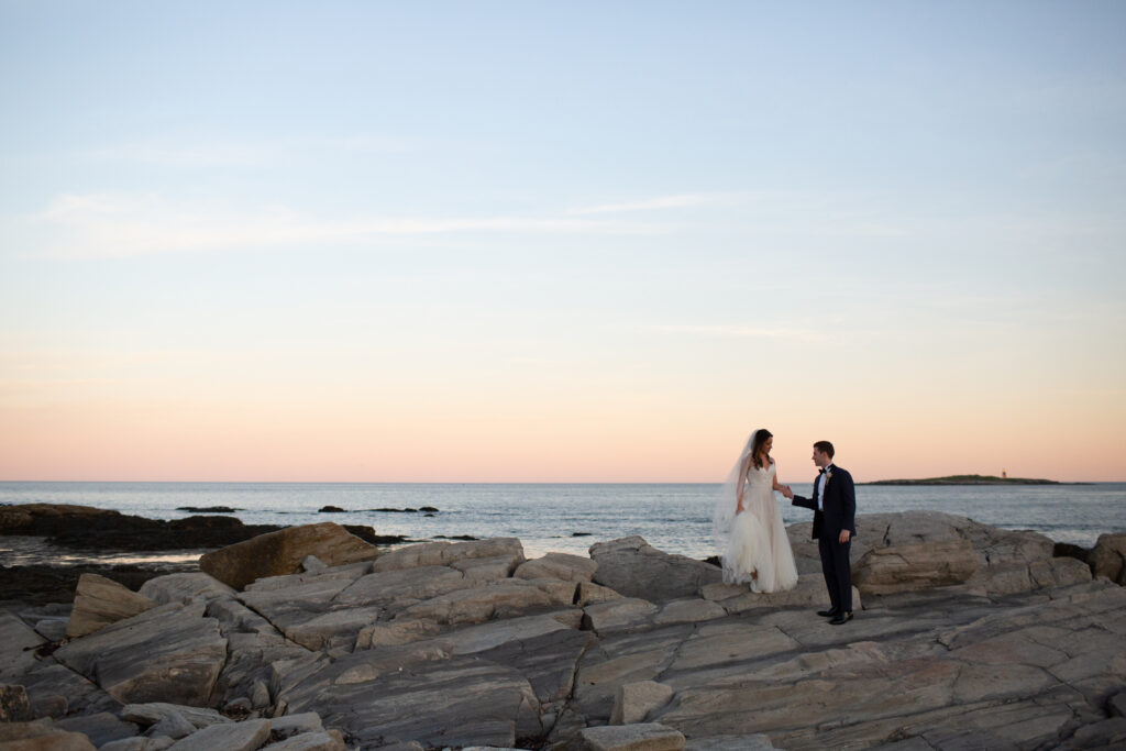 sunset with the bride and groom on the rocks 