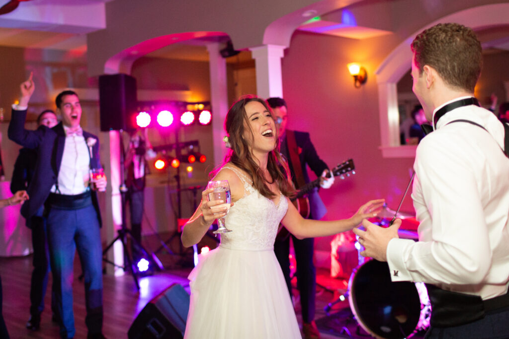 bride and groom dancing with friends