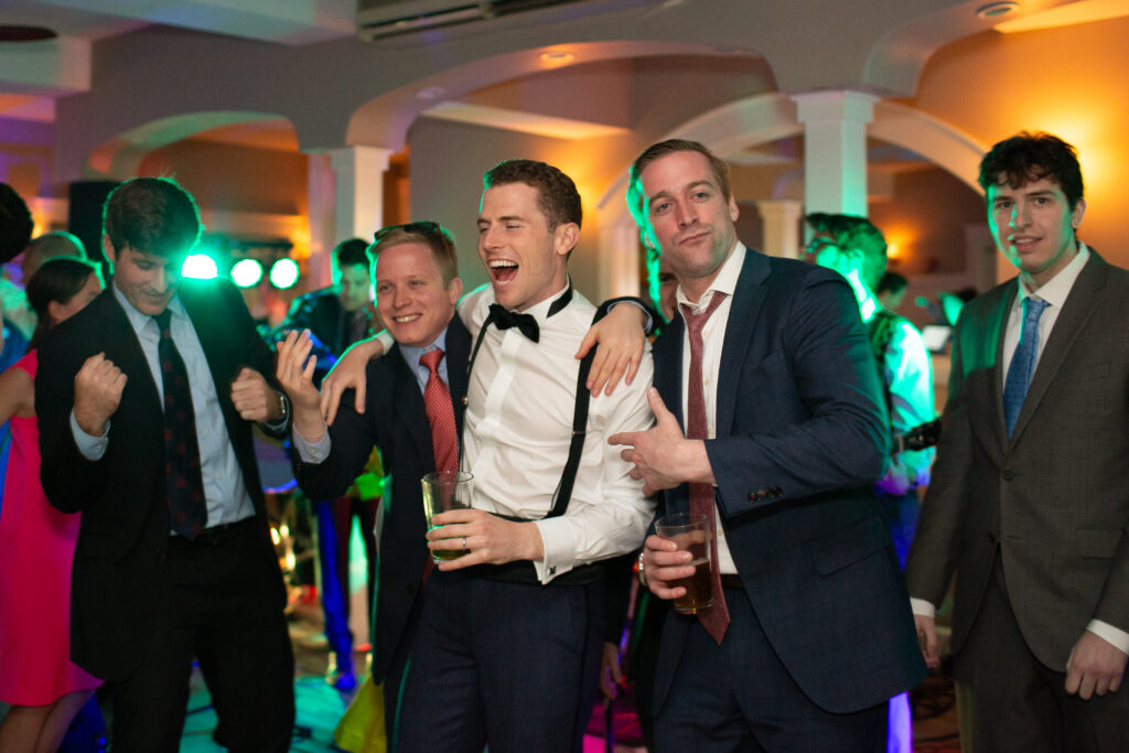 bride and groom dancing with friends