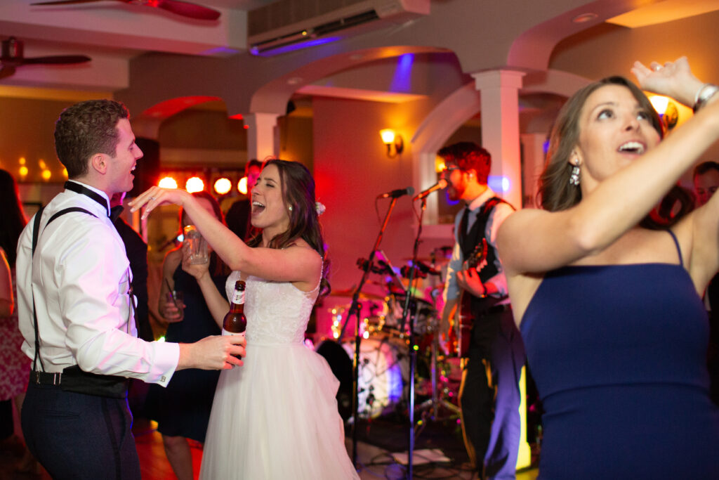 bride and groom dancing with friends