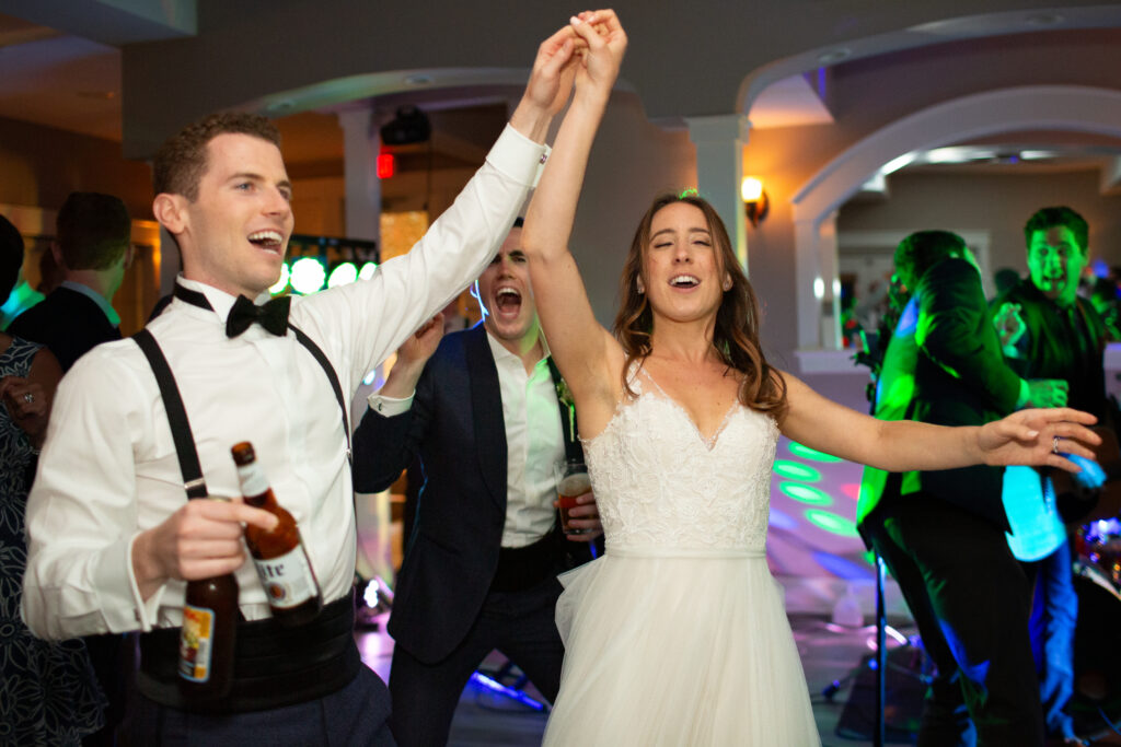 bride and groom dancing with friends