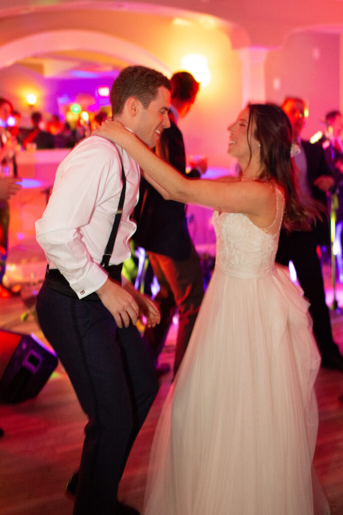 bride and groom dancing with friends