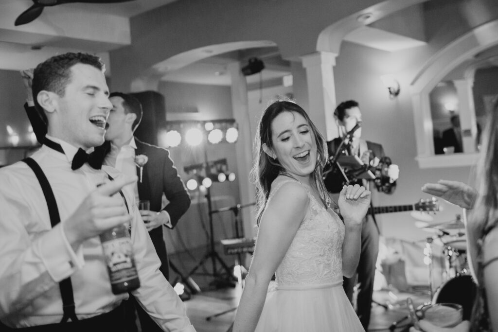 bride and groom dancing with friends