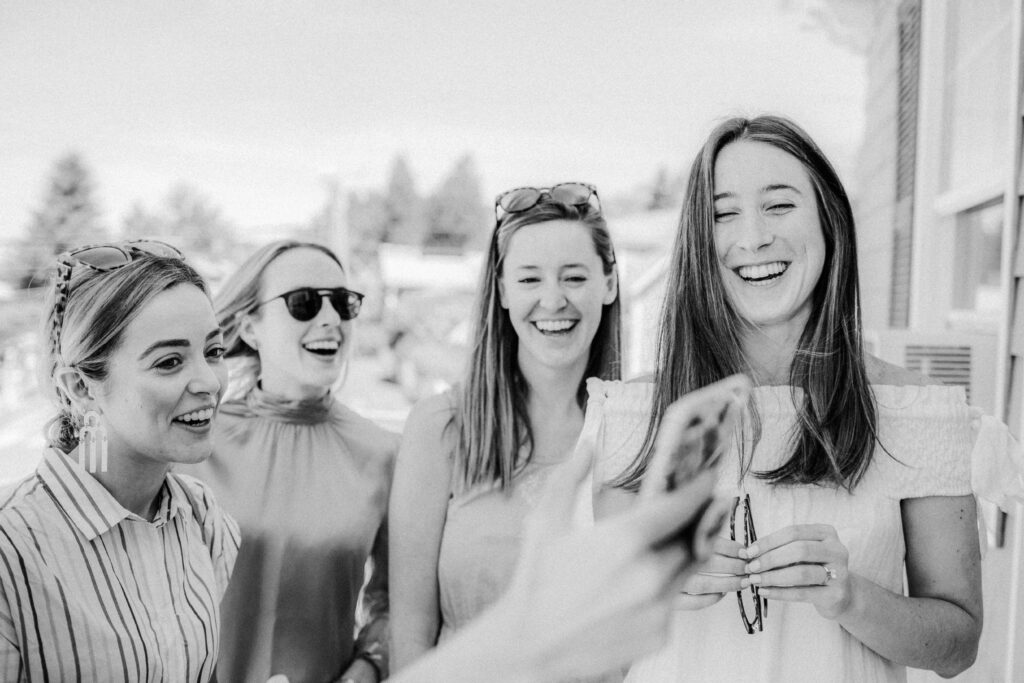 black and white of bride and friends face timing 