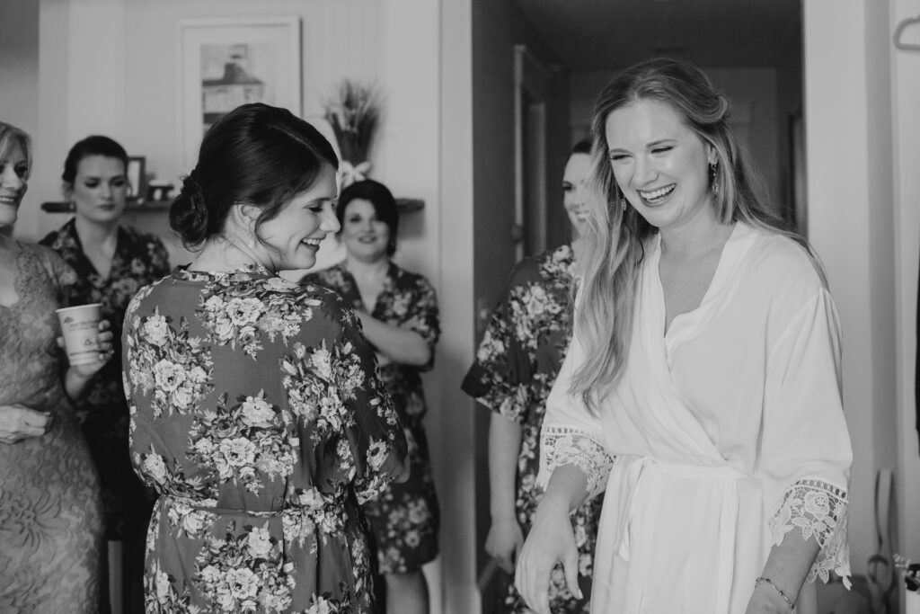 bride getting ready and laughing with her friends 