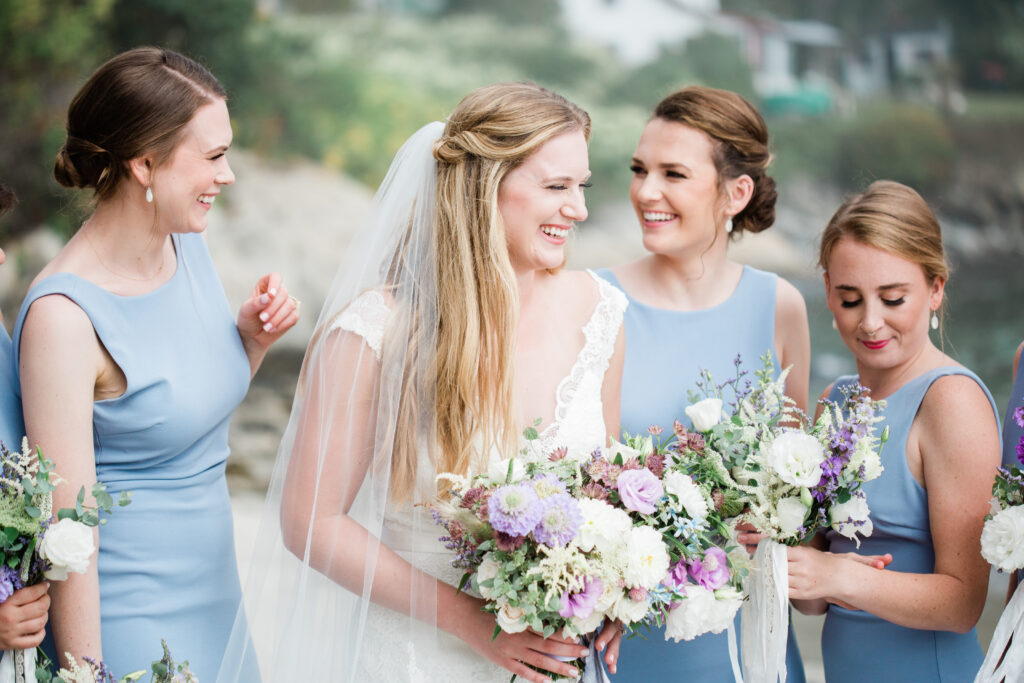 bride laughing with bridesmaids 