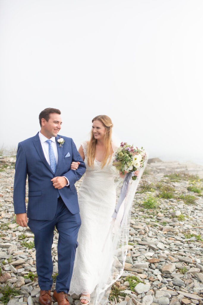 bride and groom laughing arm in arm