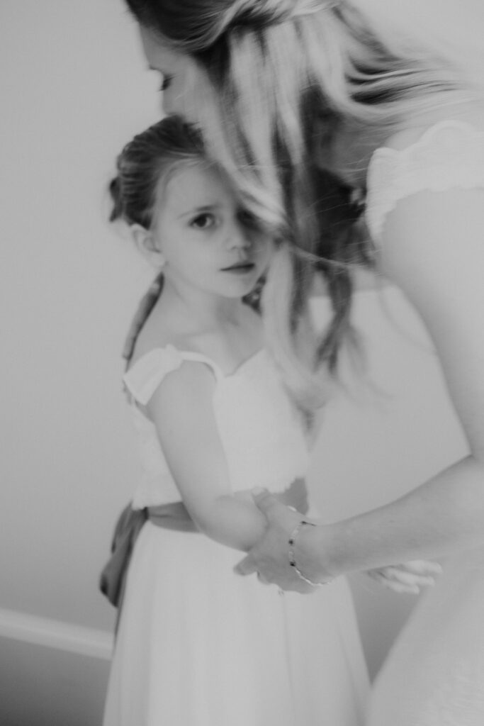 black and white of bride with flower girl 