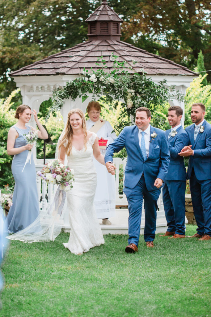 bride and groom celebrating as they leave the ceremony 