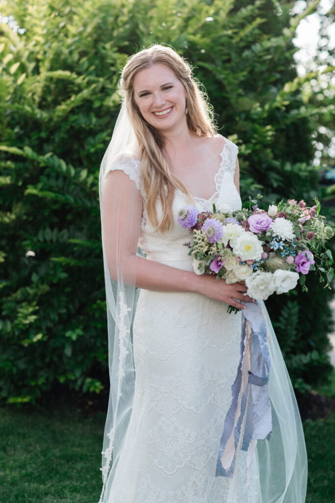 bride laughing with her bouquet