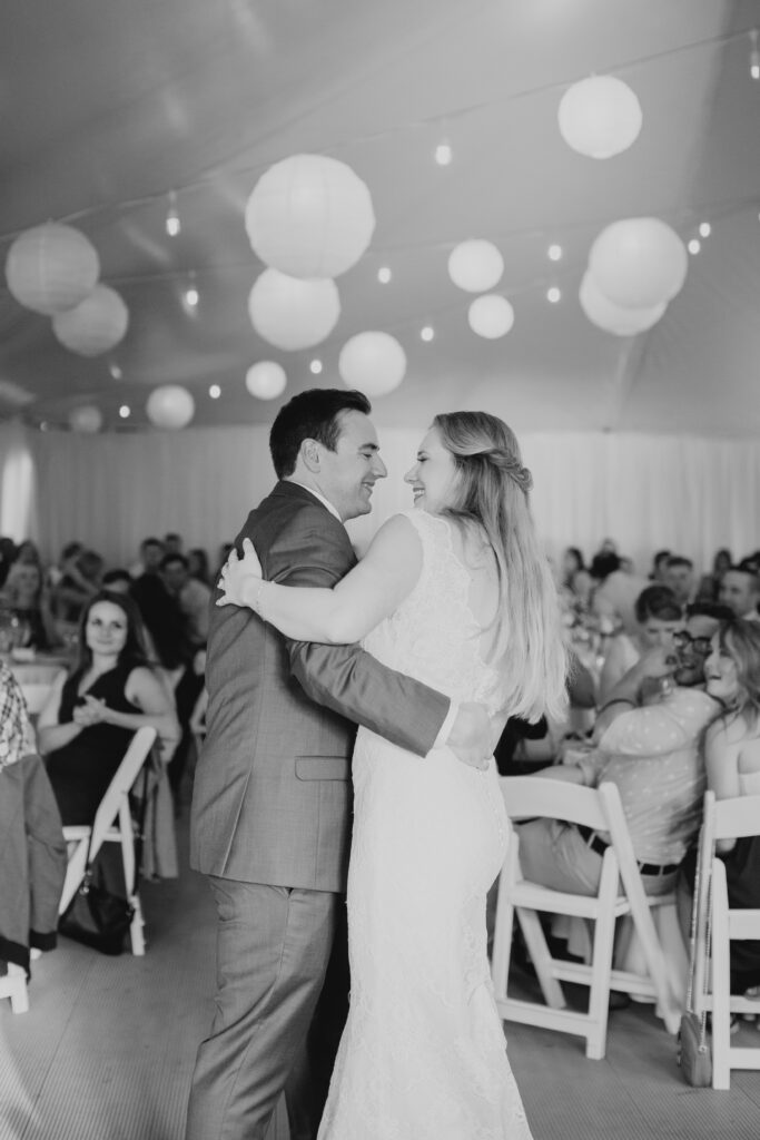 black and white of bride and groom dancing their first dance 