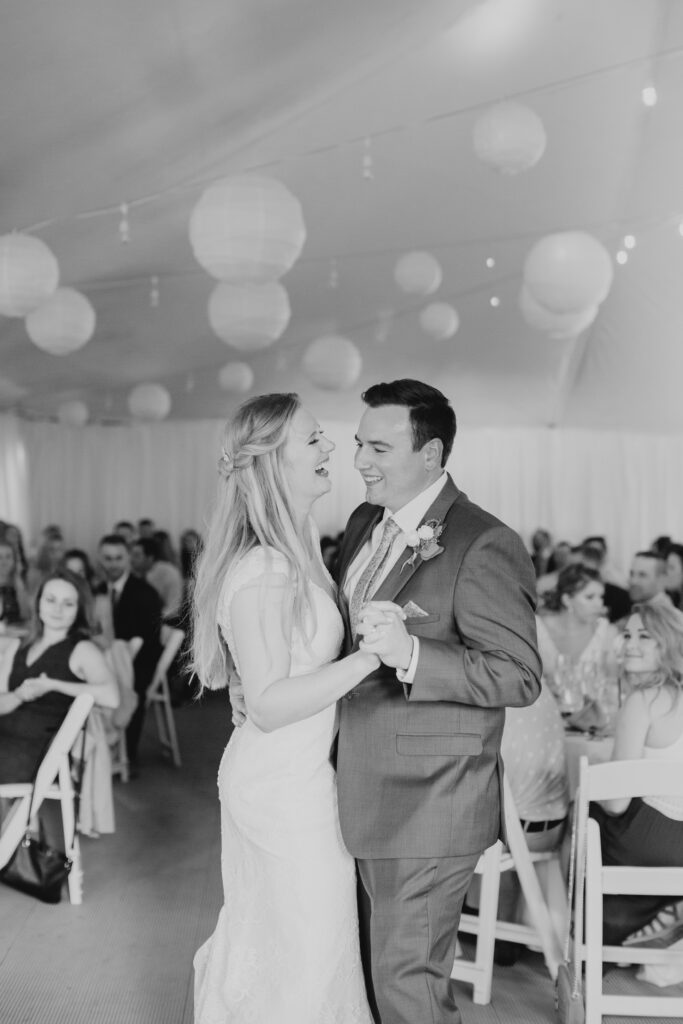 black and white of bride and groom dancing their first dance 