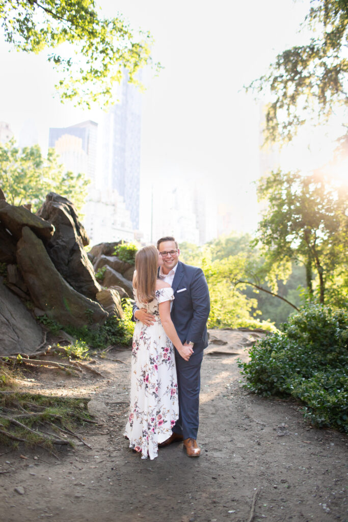 girl kissing boy on cheek in central park