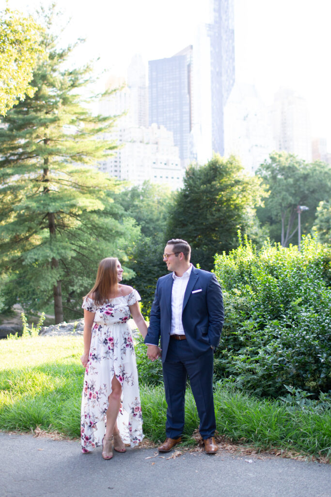 Couple in central park with skyline in background