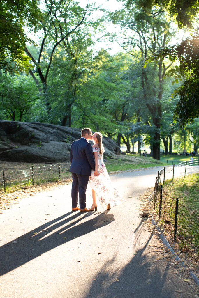 couple in sunshine kissing in central park 