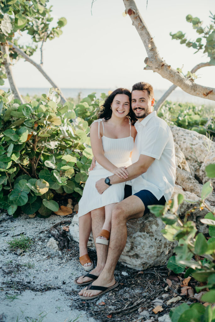 couple sitting on the rocks looking at the camera 