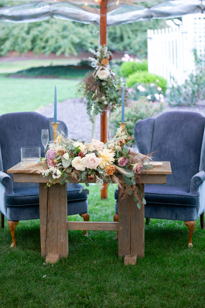 sweetheart table with large blue antique chairs 