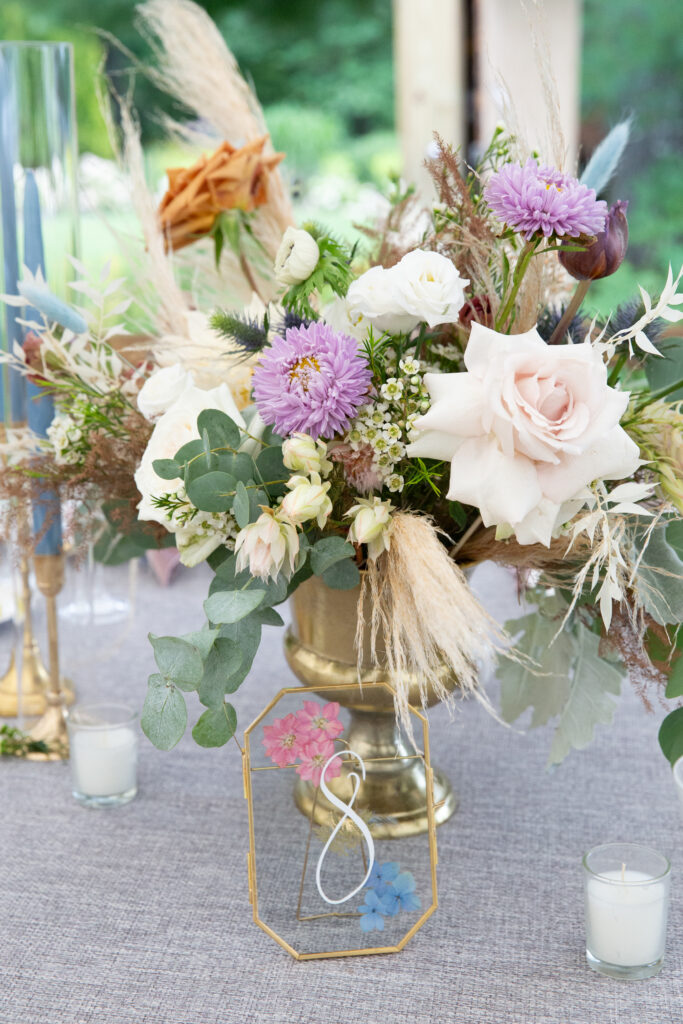 blue tall candles in gold traditional candle holders and florals 