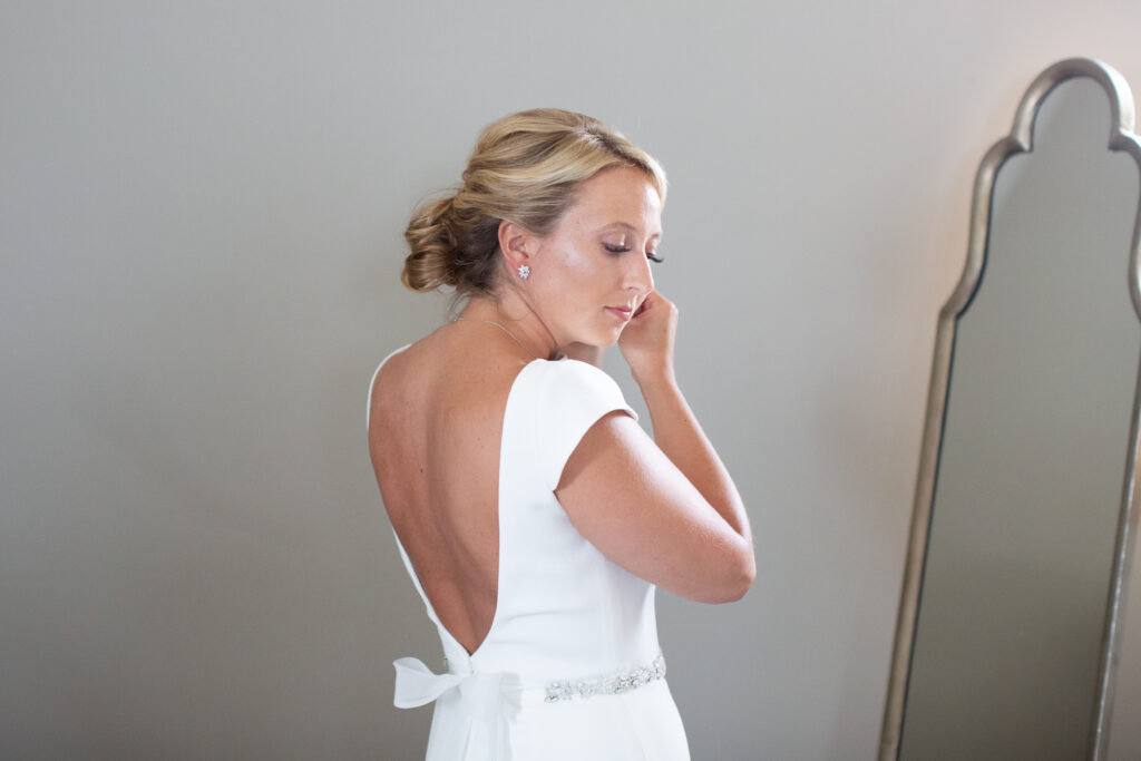 bride putting on earrings 