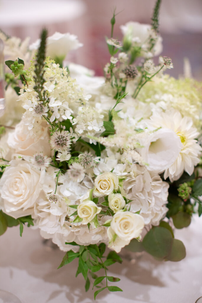 white flowers in vase on table 