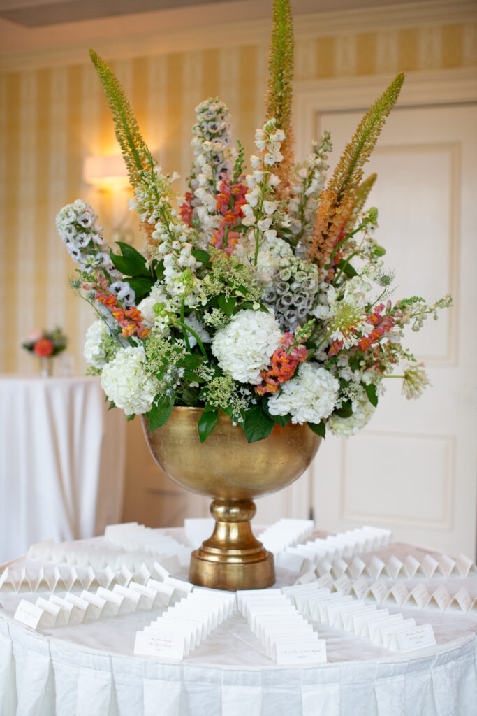 welcome table with floral arrangement and name cards