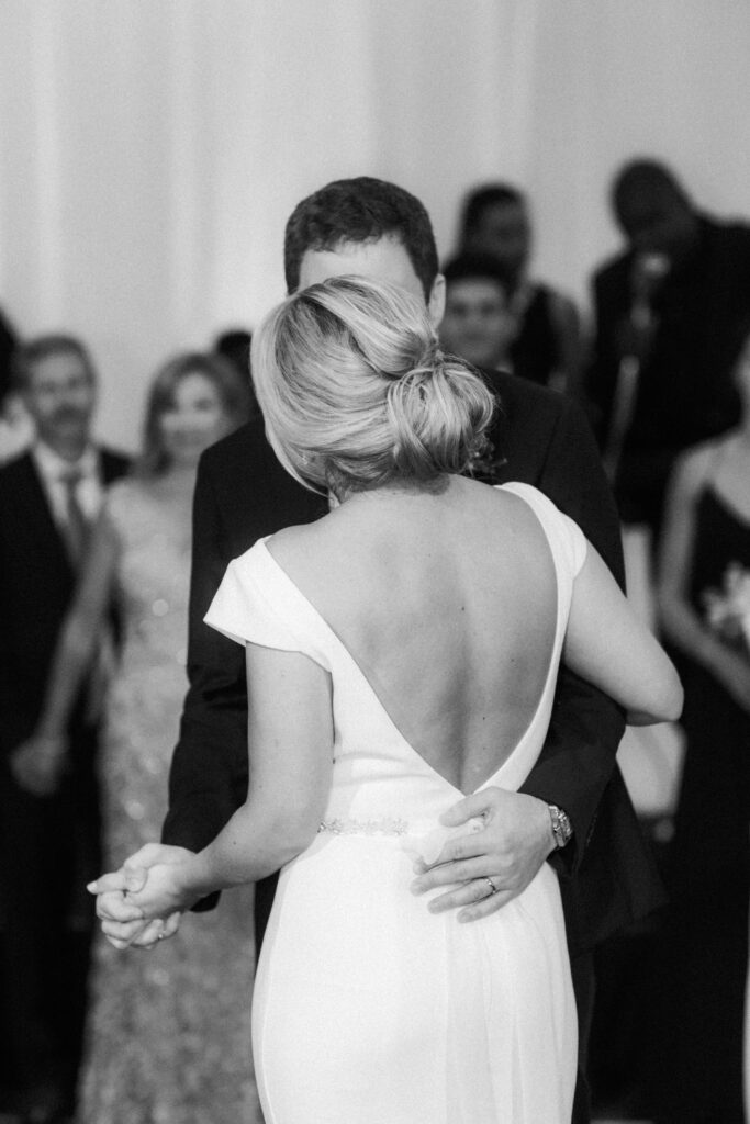 black and white picture of bride and groom dancing 