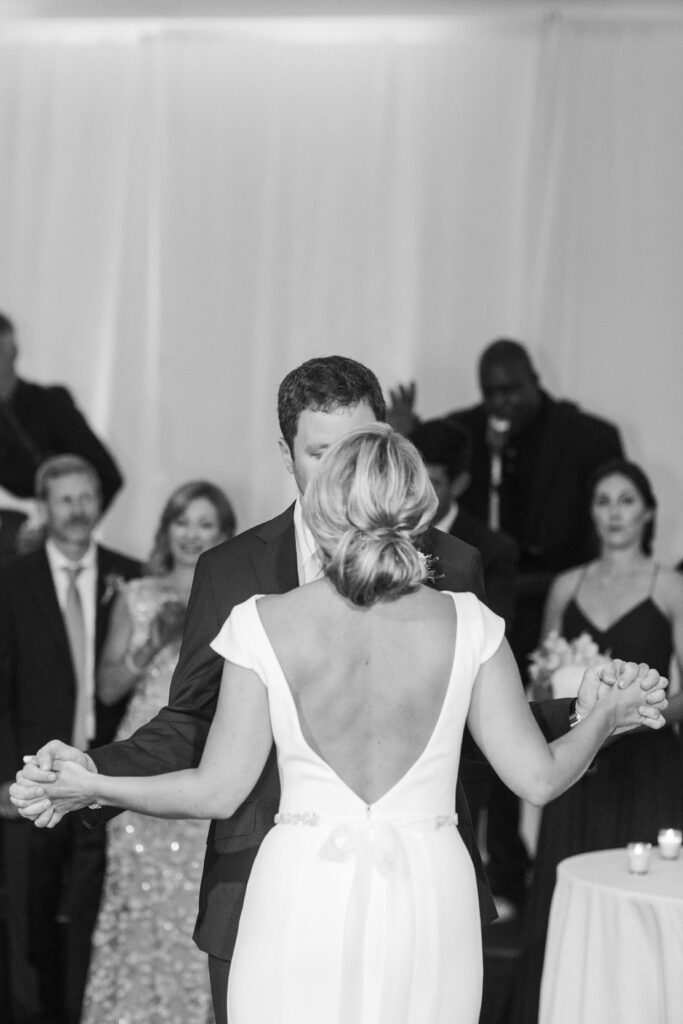 black and white picture of bride and groom dancing 