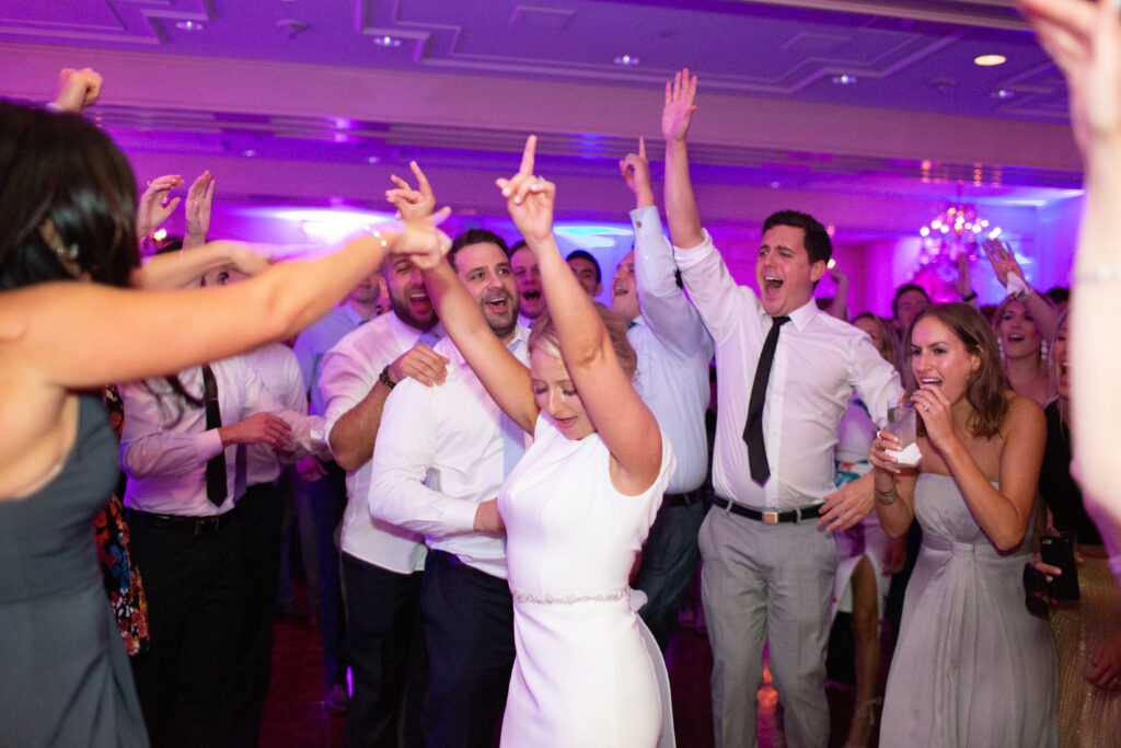 bride and groom dancing with guests 