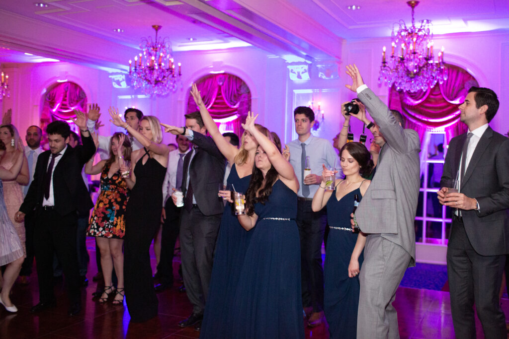 bride and groom dancing with guests 