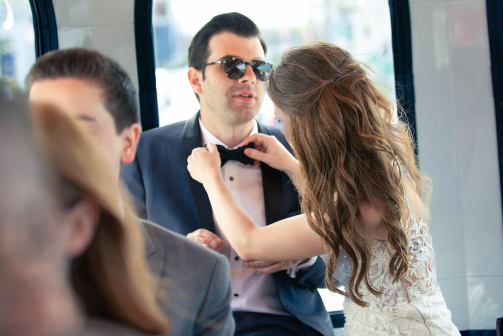 bride fixing grooms bow tie 