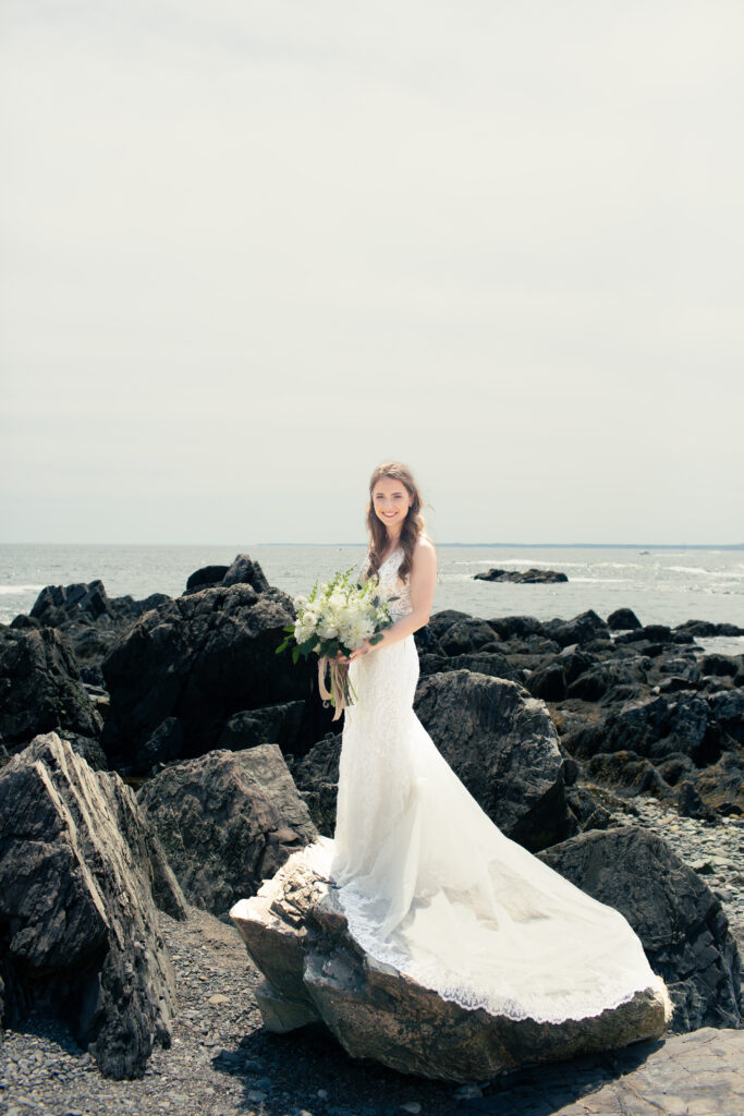 bride standing on a walk with dress flowing behind her