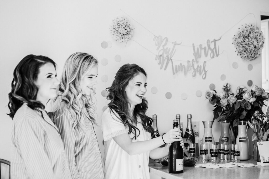 bridesmaids before wedding opening champagne 