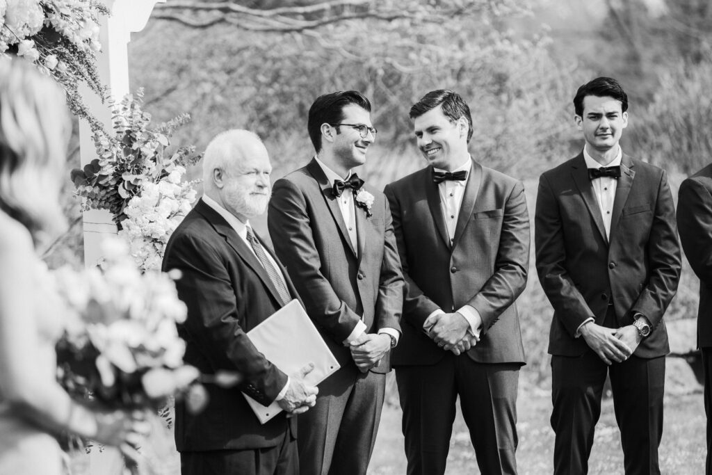 groom looking at best man waiting for bride to come down the aisle 