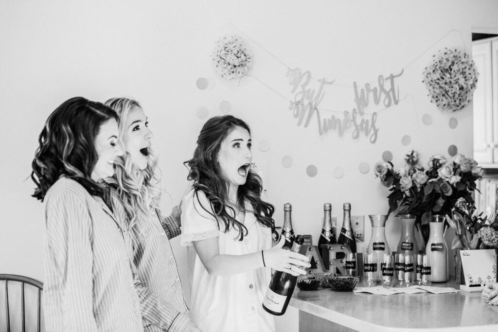 bridesmaids before wedding opening champagne 