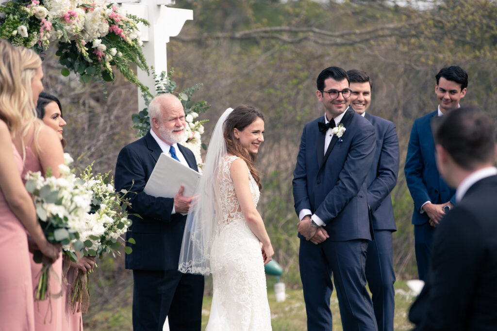 bride and groom laughing during wedding ceremony 