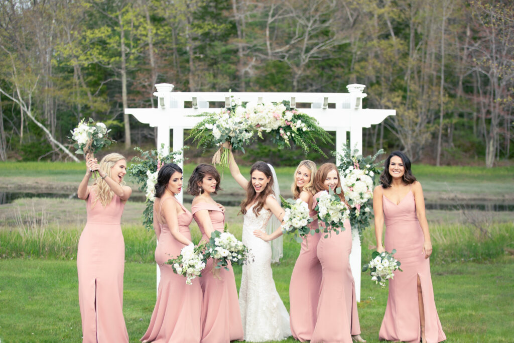 bridesmaids wearing pink and being sassy in group photo 