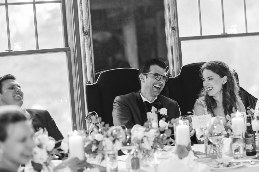 groom laughing at toasts 