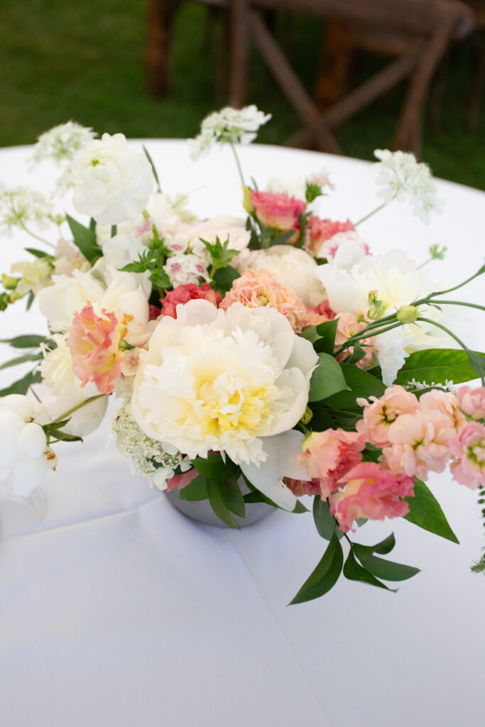 floral centerpieces with white peonies and pink accents