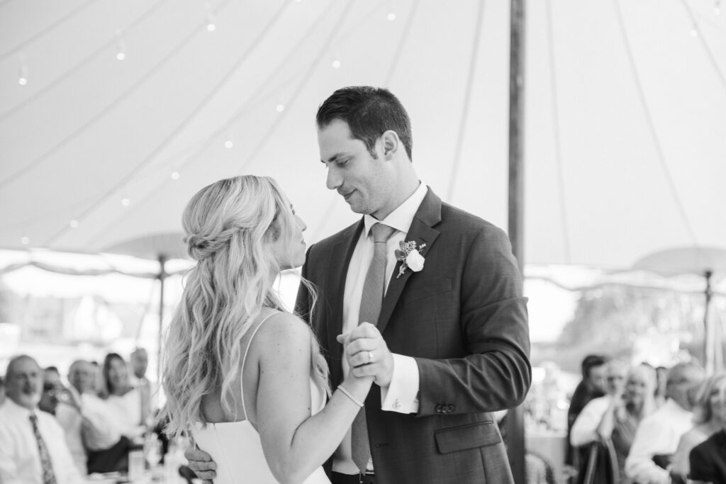 black and white of bride and groom dancing 