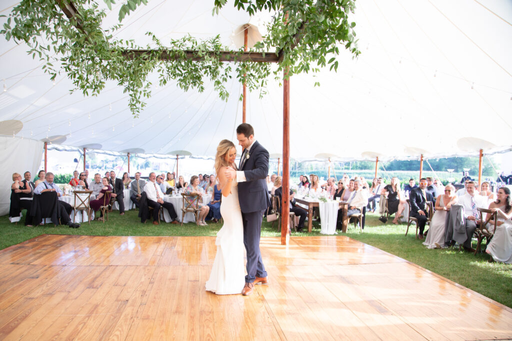 bride and groom dancing their first dance under the floral ceiling installation 